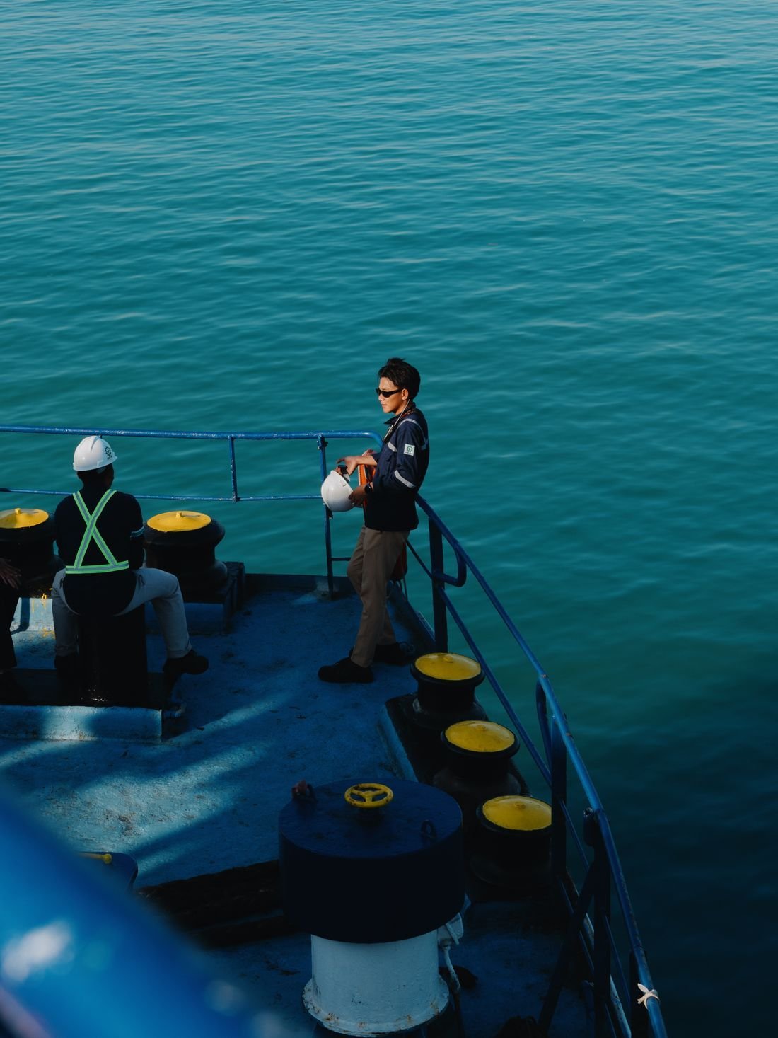 Crew members working on a ship's deck at sea